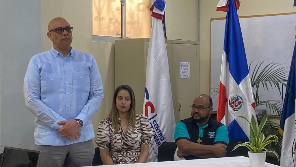 El director ejecutivo del CNCS, Juan Gabriel Gautreaux, del Instituto Salesiano Don Bosco, el padre Wilson Rosario y Bianca Pouerie del CNCS.